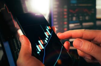 Hands holding smartphone showing stock market data